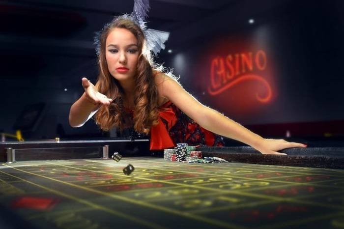 Mobile phone displaying Monopoly Live game board on liga778 login with betting interface and live host visible